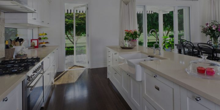 kitchen with countertop with sink flowers to decorate and open patio door to garden