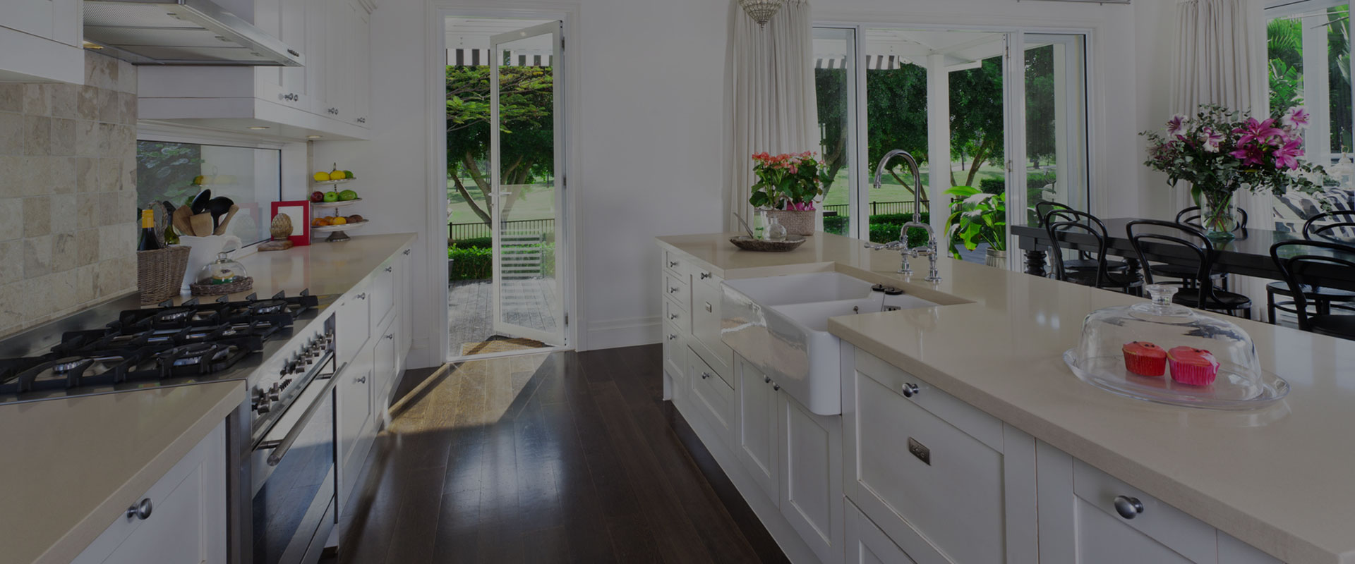 kitchen with countertop with sink flowers to decorate and open patio door to garden